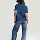 Back view of woman wearing cute print blue t-shirt for women paired with denim jeans and a cap