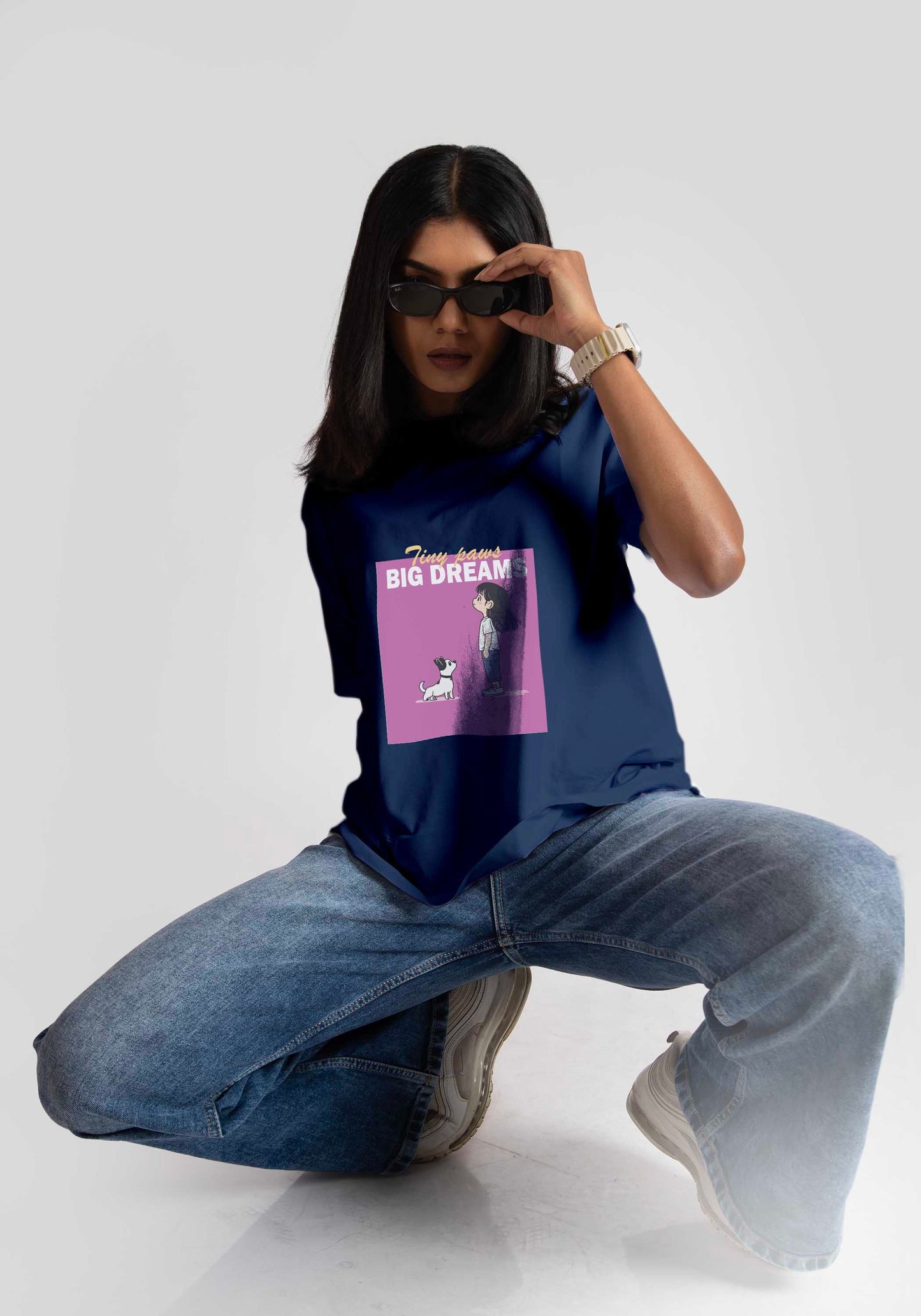 Woman wearing a cute print blue t-shirt for women by Stylera paired with jeans and sunglasses