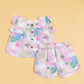 Cute summer outfit for kids featuring a colorful ruffled top and matching shorts