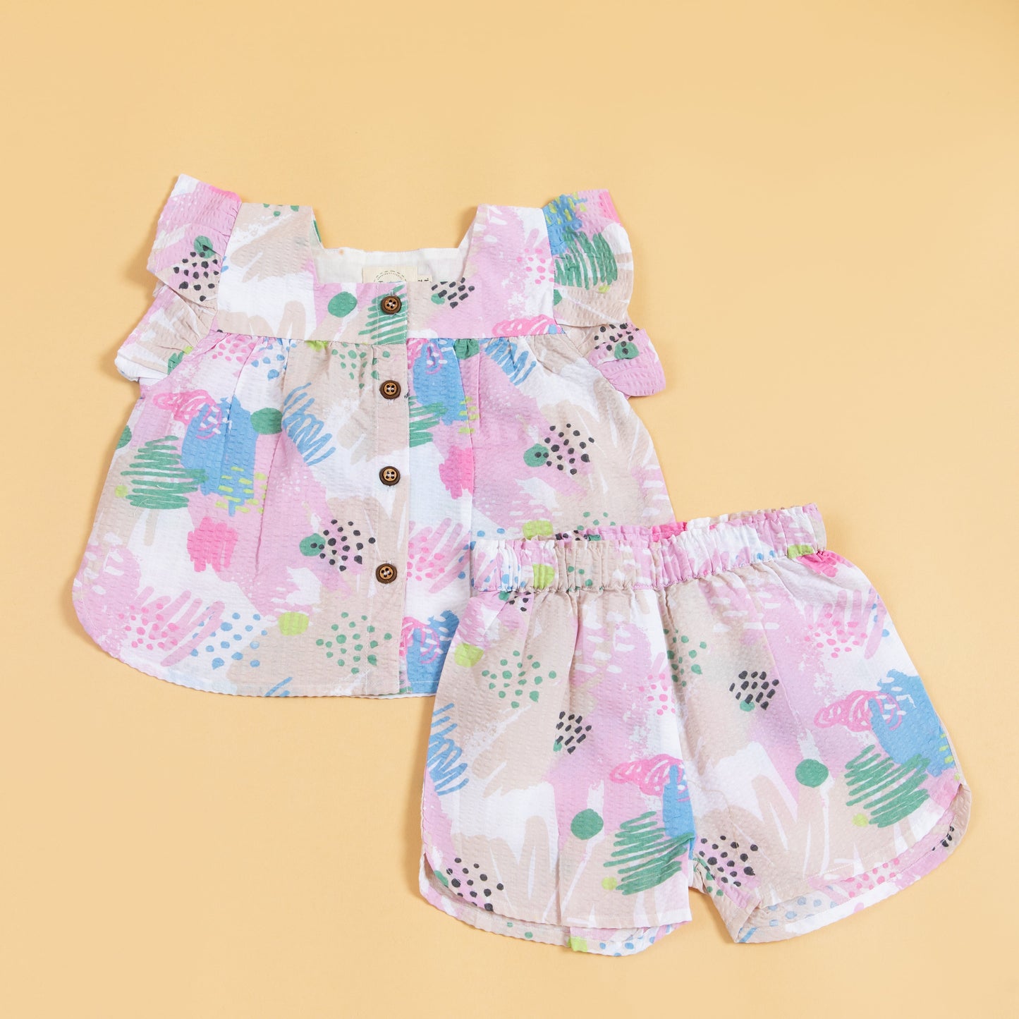Cute summer outfit for kids featuring a colorful ruffled top and matching shorts
