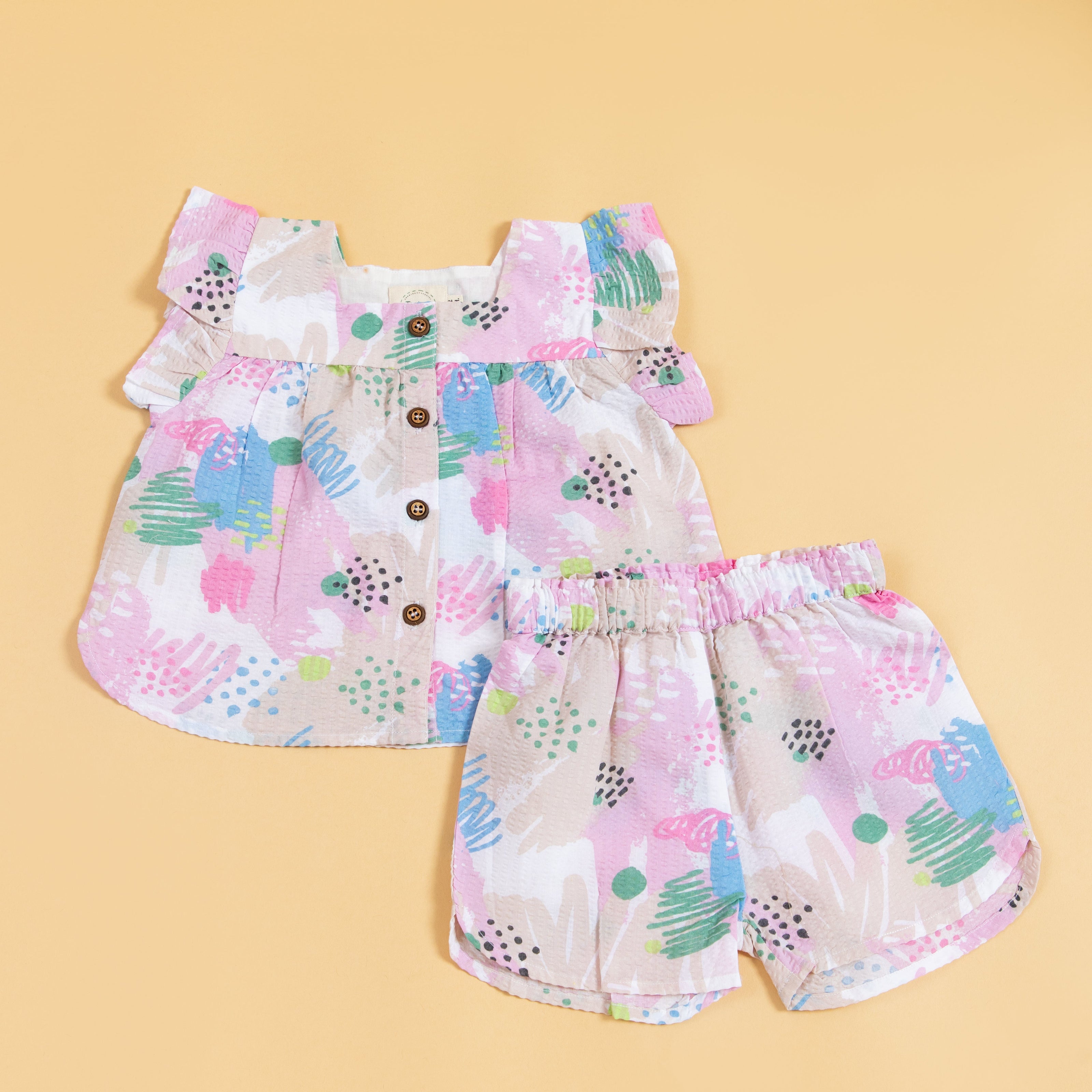 Cute summer outfit for kids featuring a colorful ruffled top and matching shorts