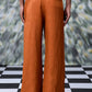 Back view of Stylera dark camel linen trousers with wide legs and belt loops