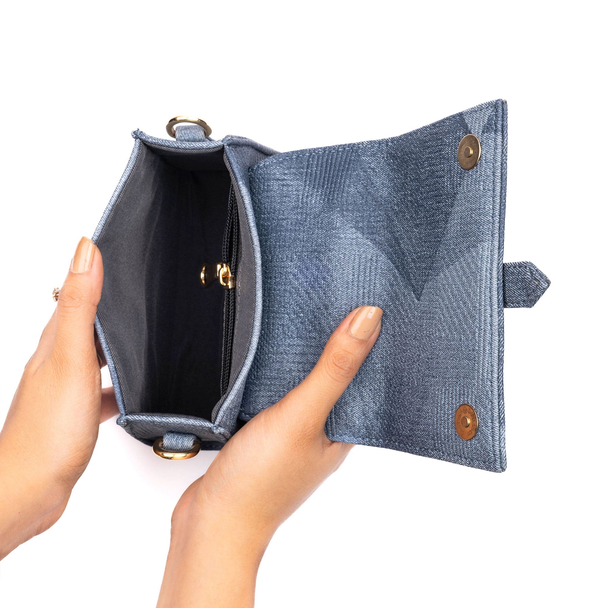 Open denim mini sling bag showcasing its inner compartments and stylish design