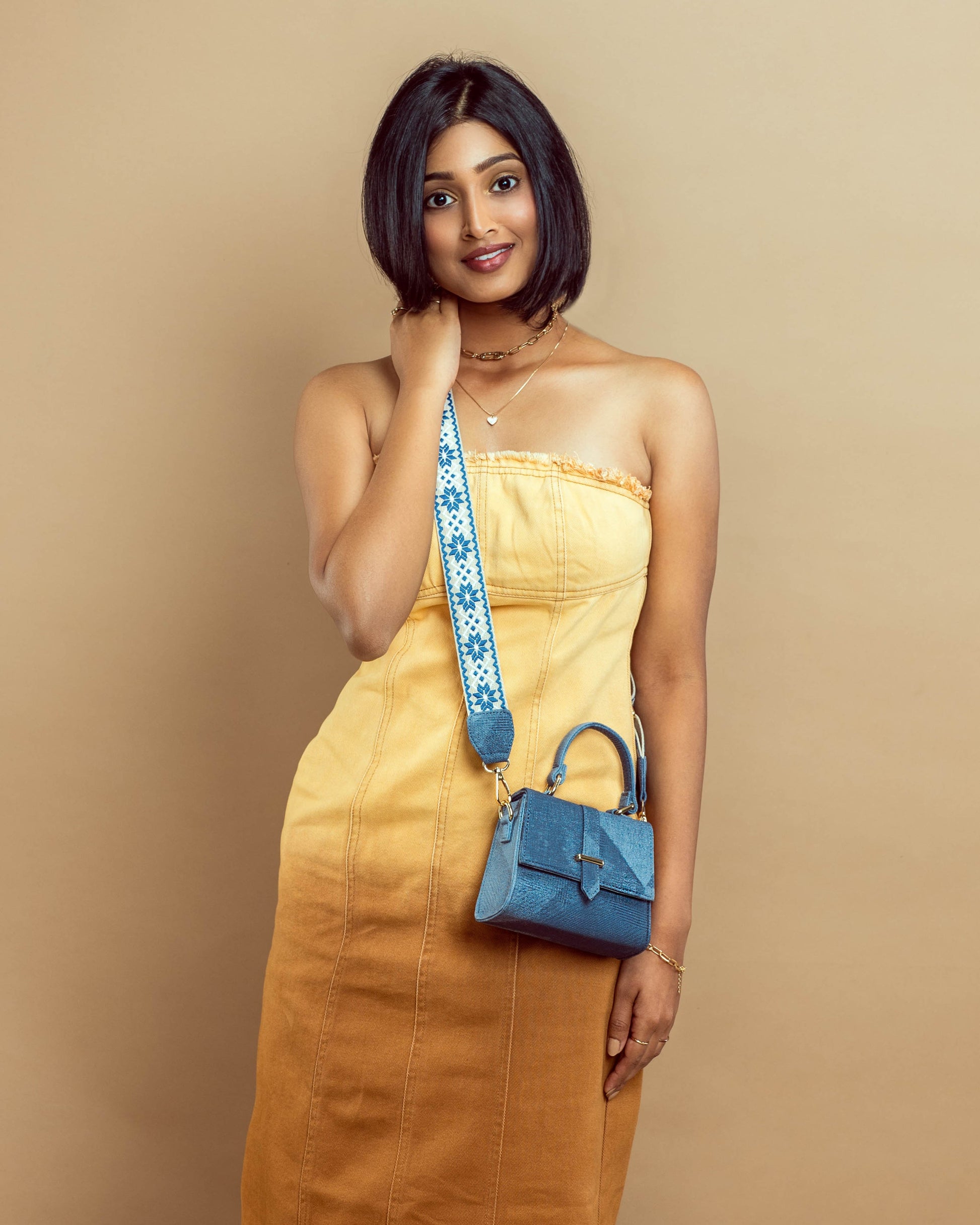 Stylish denim mini sling bag by Stylera with a unique strap design, perfect for casual outings