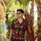 Men's designer animal print shirt for men featuring vibrant floral patterns in a tropical setting