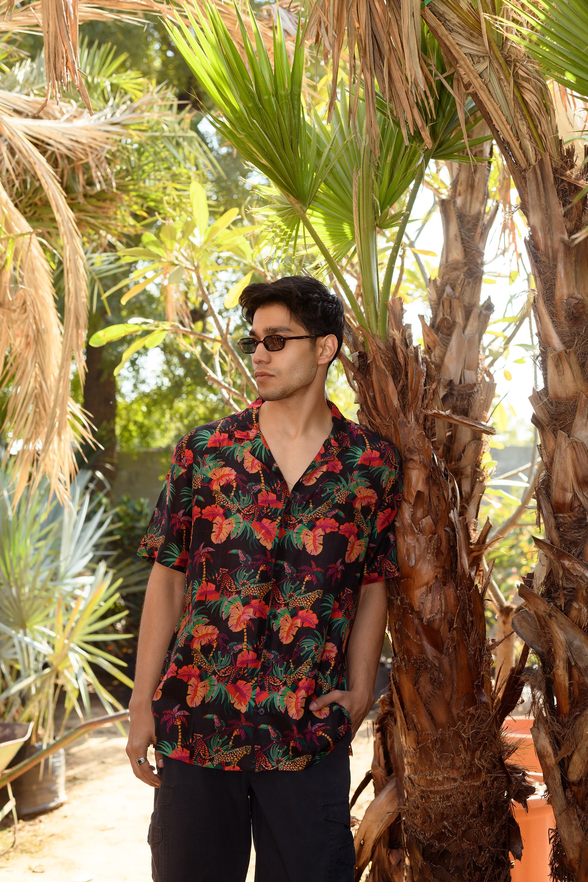 Men's designer animal print shirt for men featuring vibrant floral patterns in a tropical setting