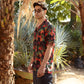 Men's designer animal print shirt for men in vibrant colors set against a tropical background