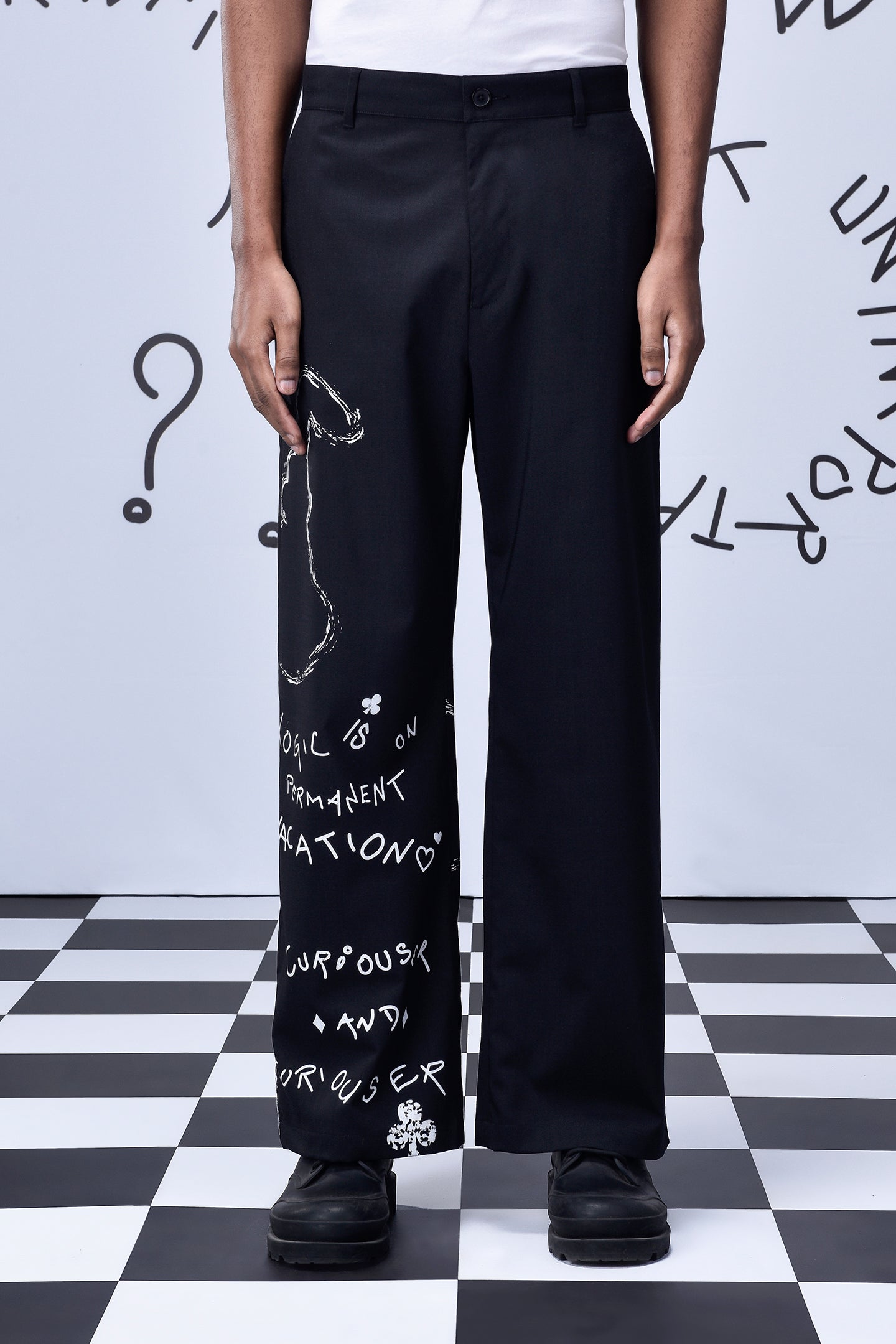 Designer black wool trousers by Stylera with white graphic text on one leg