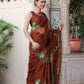Elegant designer brown saree for wedding featuring floral embroidery, worn by a model in a festive setting