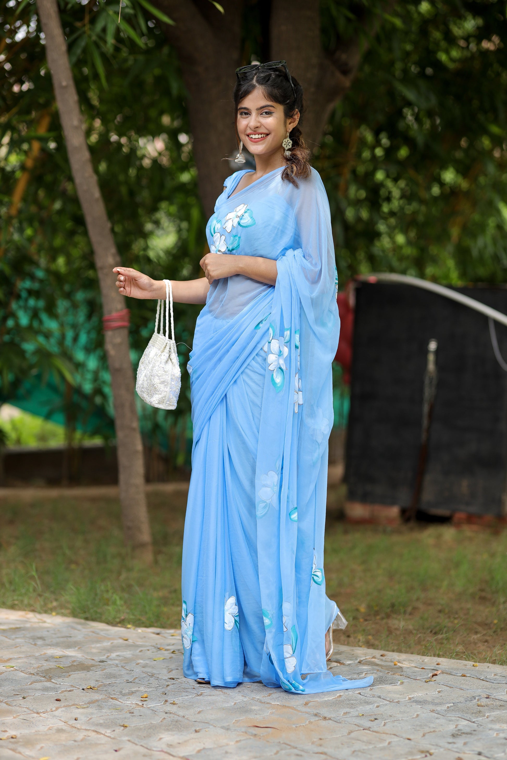 DiraByDimple designer chiffon saree with floral painting in light blue, perfect for special occasions.