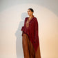 Elegant designer evening gown for women featuring a flowing design in rich burgundy and brown tones
