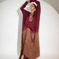 Model wearing a designer evening gown for women with a stylish ombre effect in burgundy and brown