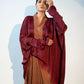 Elegant designer evening gown for women featuring flowing sleeves and rich burgundy tones