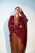 Elegant designer evening gown for women featuring flowing sleeves and rich burgundy tones