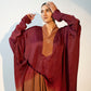 Elegant designer evening gown for women in rich burgundy and brown hues with dramatic sleeves