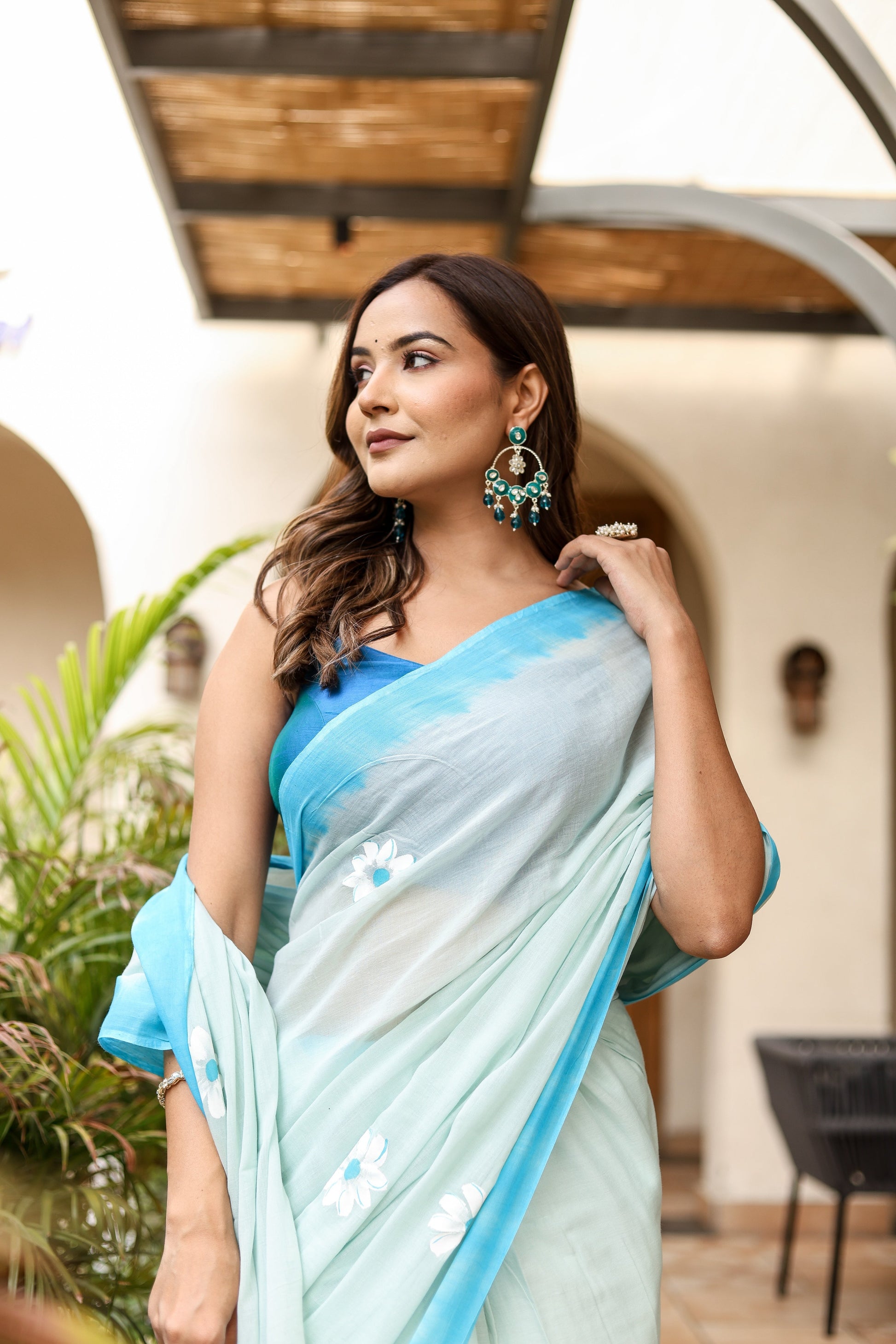 Elegant designer handpainted saree for parties in light blue with floral designs