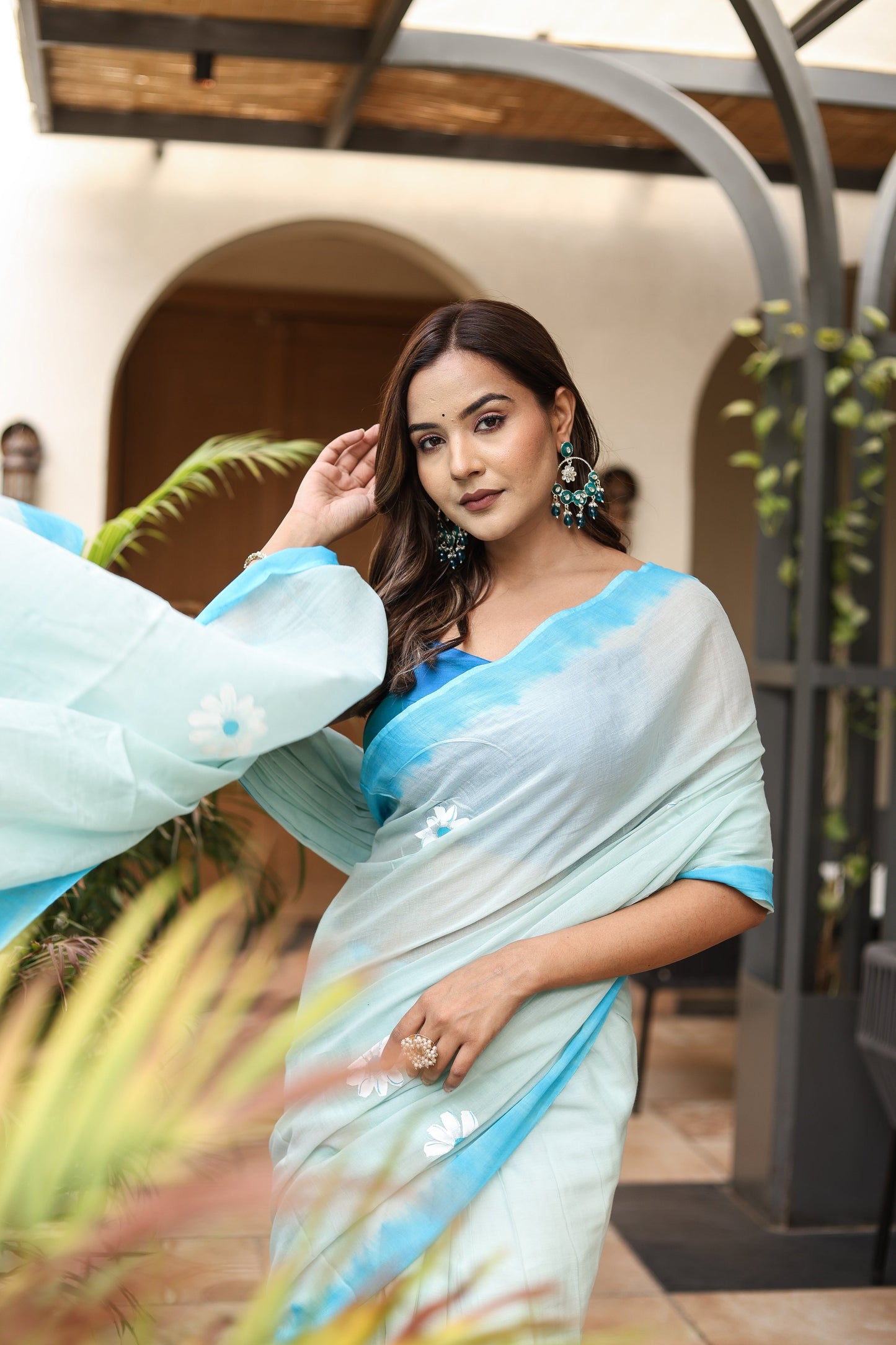Elegant Stylera designer handpainted saree for parties in blue and white with floral designs