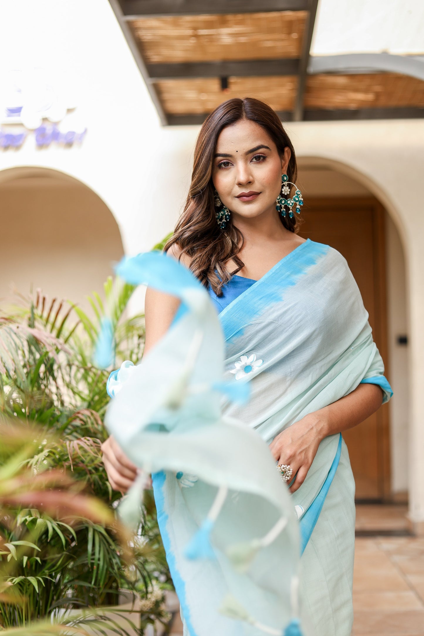 Stylera designer handpainted saree for parties in soft blue hues with elegant flow and detailing