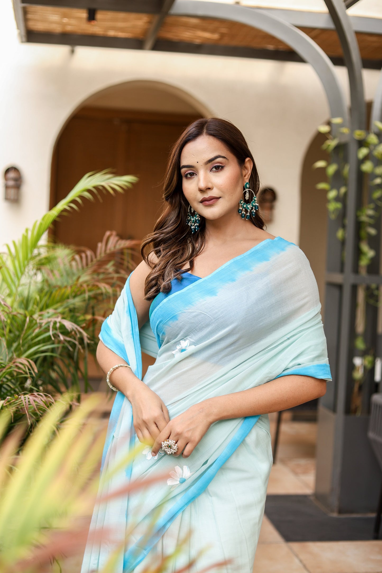 Elegant Stylera designer handpainted saree for parties in soft blue shades with floral details