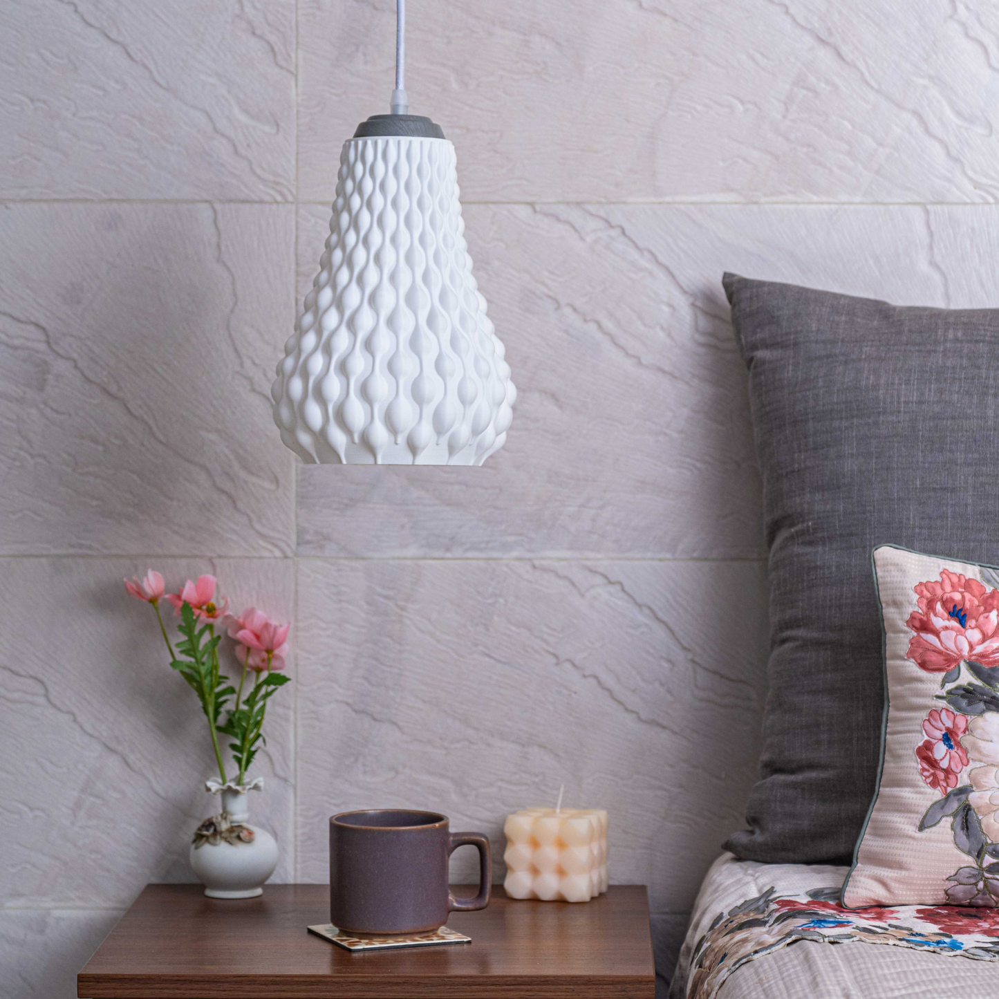 Sozori designer hanging droplet lamp with a unique textured design illuminating a cozy living space