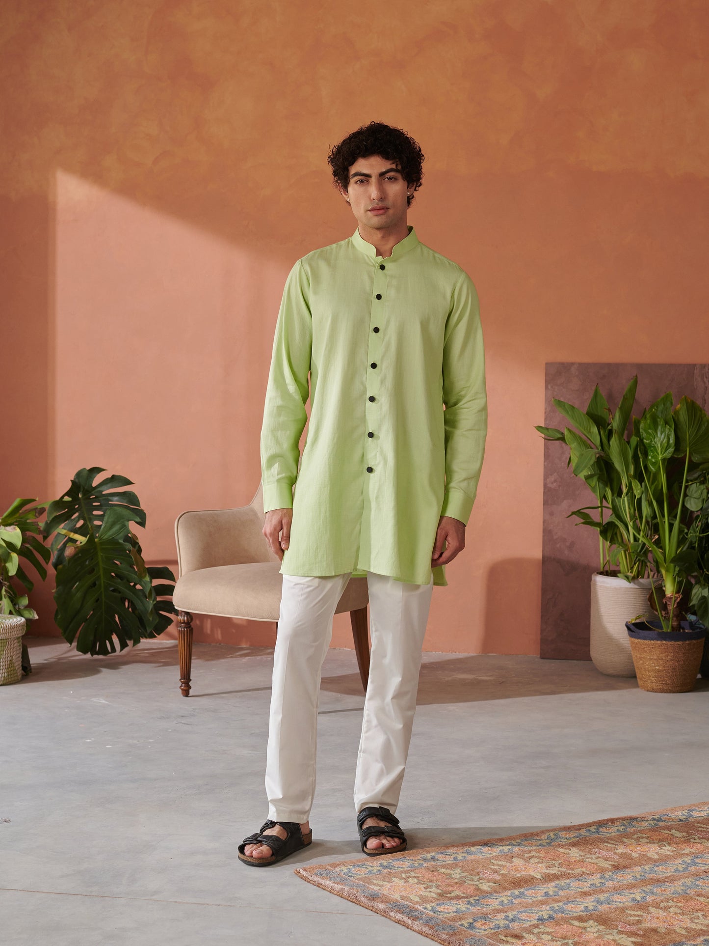 Men's designer kurta for men in light green with buttons, paired with white pants and black sandals