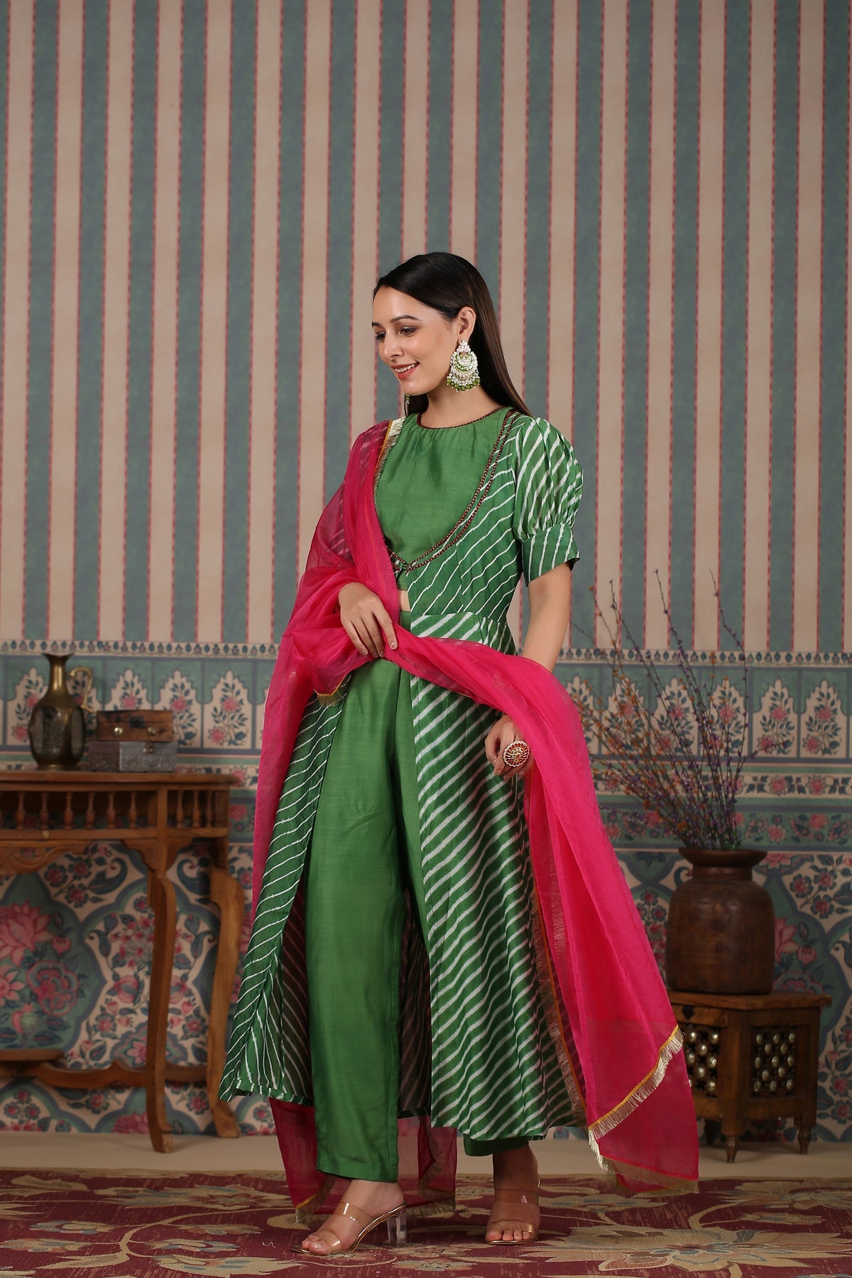 Elegant designer lehriya dress for women with a flowing green silhouette and pink dupatta