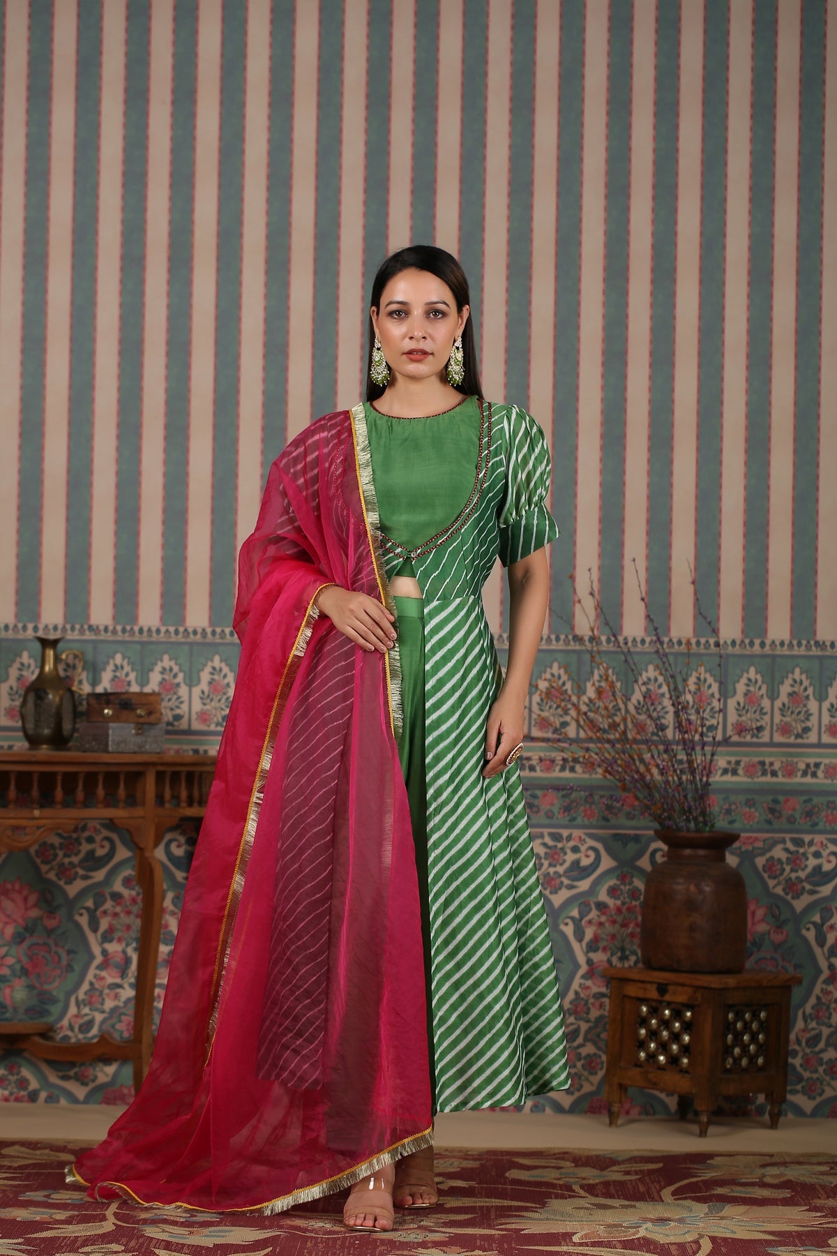 Elegant designer lehriya dress for women featuring a green and pink color scheme with flowing style