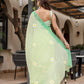 Stylish designer malmal saree with flowers in light green, elegantly draped for a chic look