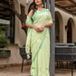 Elegant designer malmal saree with flowers in light green, perfect for festive occasions
