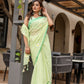 Elegant designer malmal saree with flowers in pastel green, perfect for festive occasions and casual gatherings