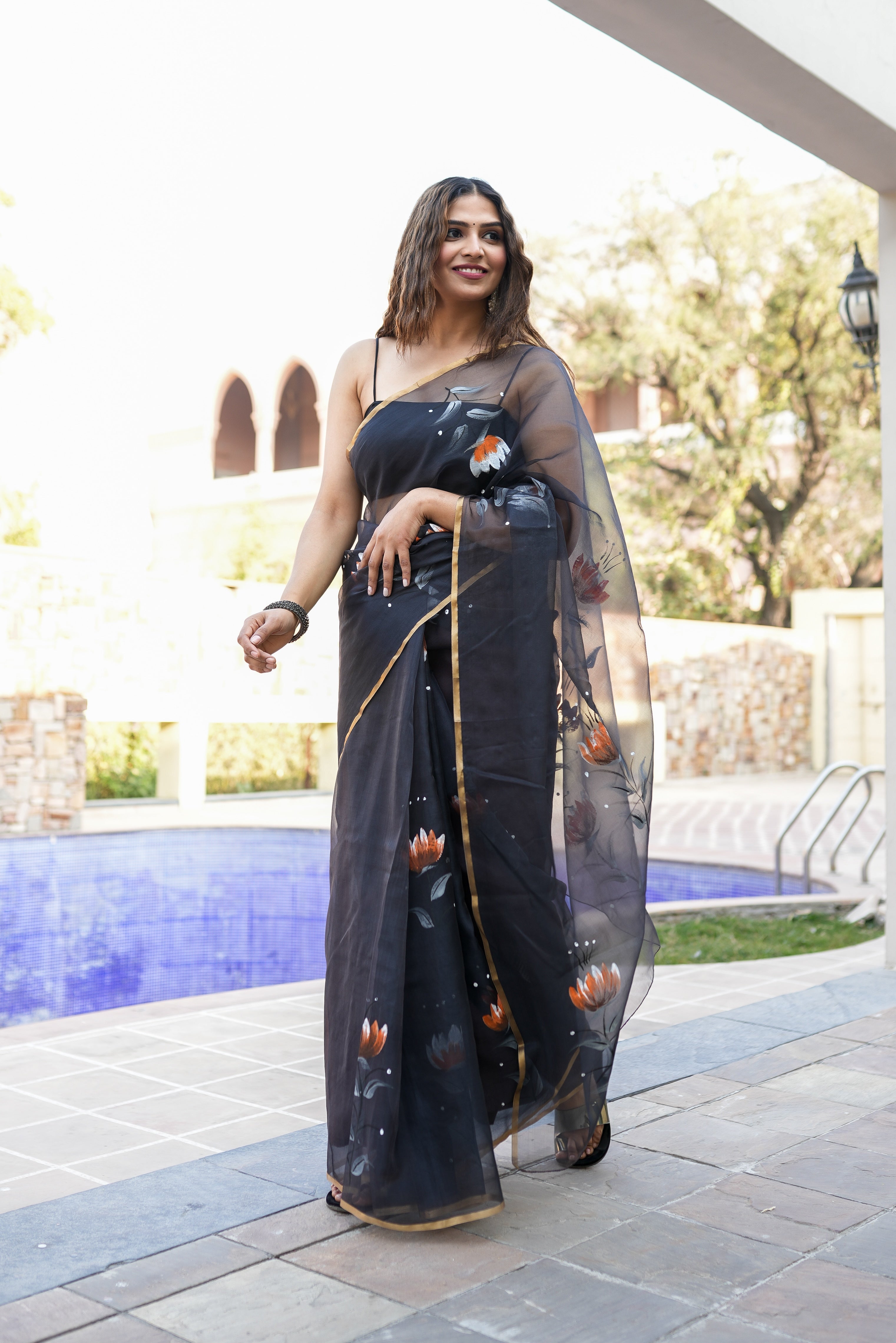 Elegant black designer party wear saree for women with floral motifs and sheer fabric, perfect for special occasions