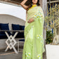 Elegant designer party wear saree in light green with floral embroidery for special occasions