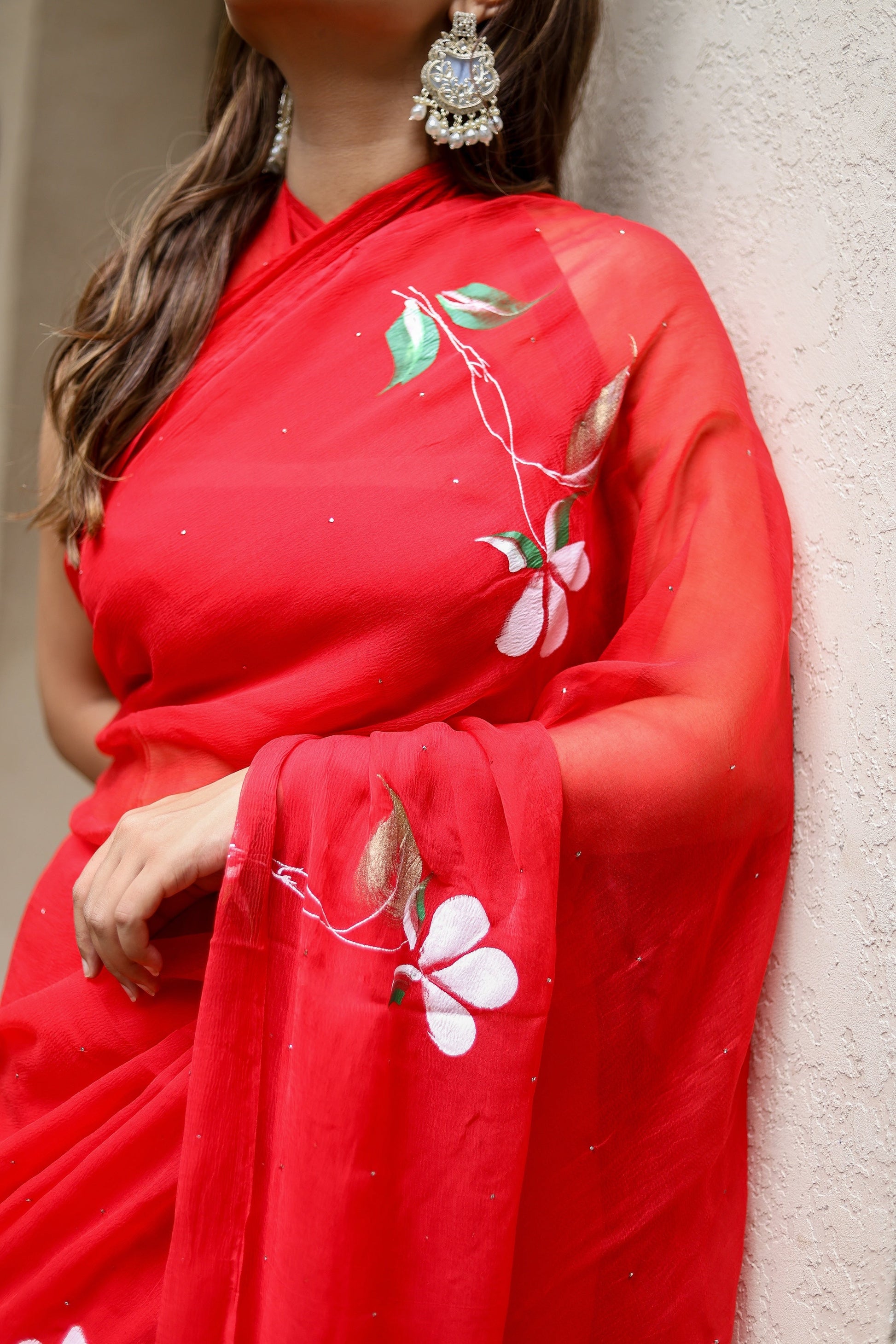 Elegant designer red saree for weddings with floral embroidery and sequins for a sophisticated look