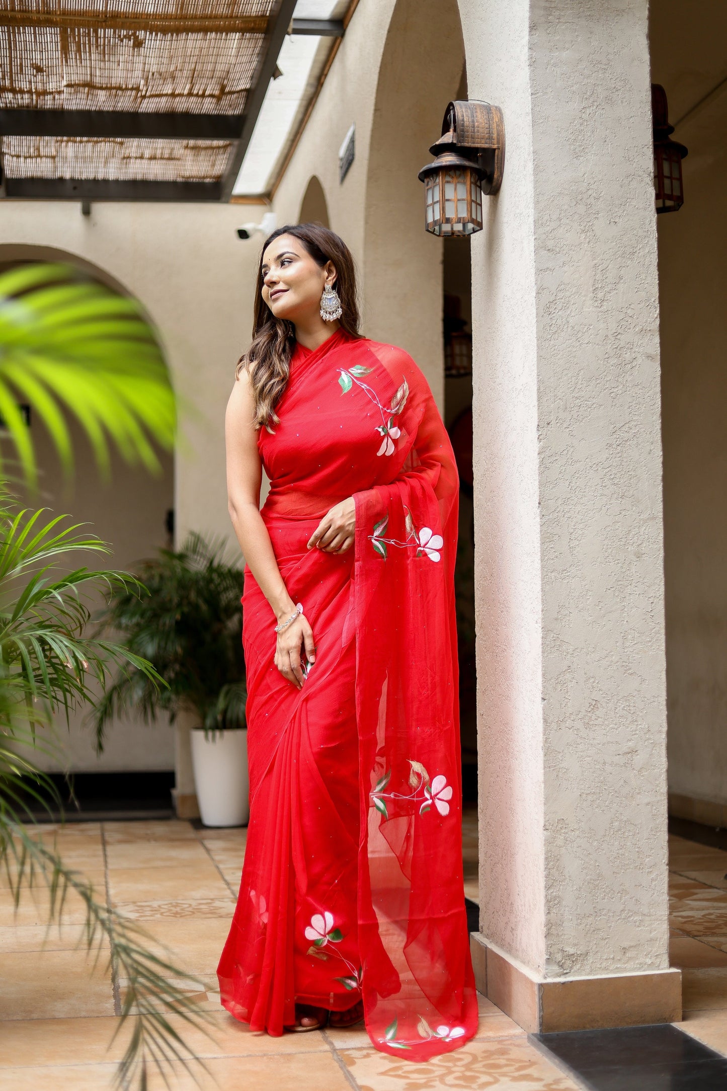 Elegant designer red saree for weddings with floral embroidery, perfect for special occasions