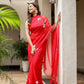 Elegant designer red saree for weddings with floral embroidery, styled with matching accessories