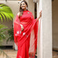 Elegant designer red saree for weddings featuring floral embroidery and a flowing silhouette