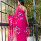 Elegant pink designer saree for special occasions with floral embroidery, worn over a stylish top