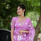 Elegant designer saree for special occasions in purple with floral patterns, paired with matching earrings
