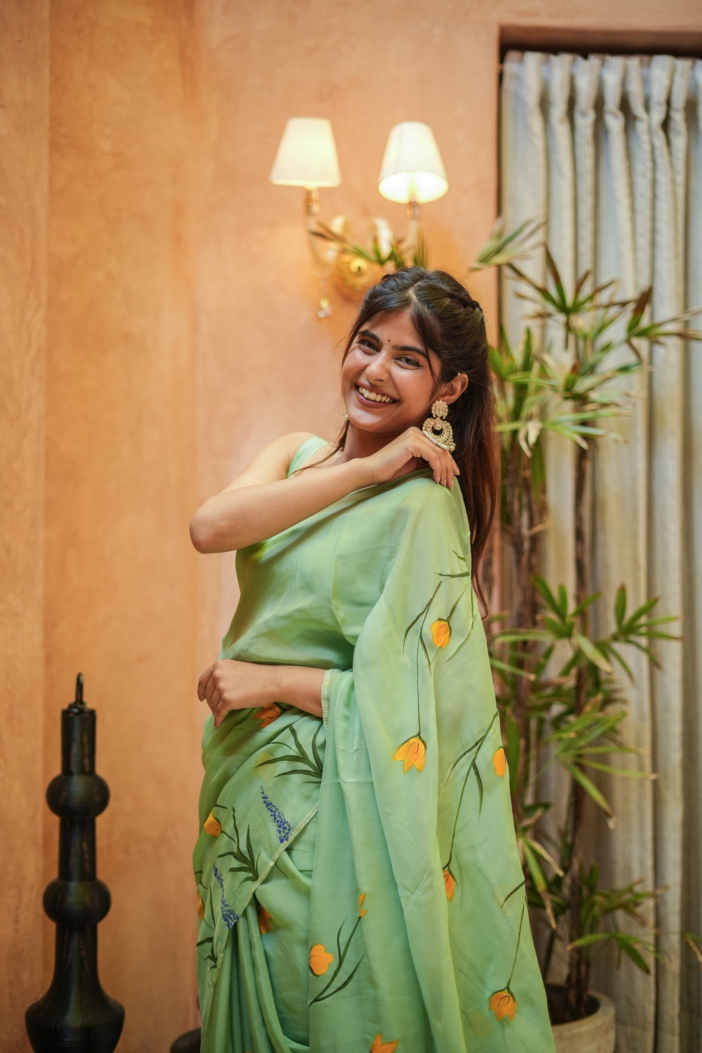 Elegant designer saree for women in pastel green with floral embroidery, perfect for festive occasions