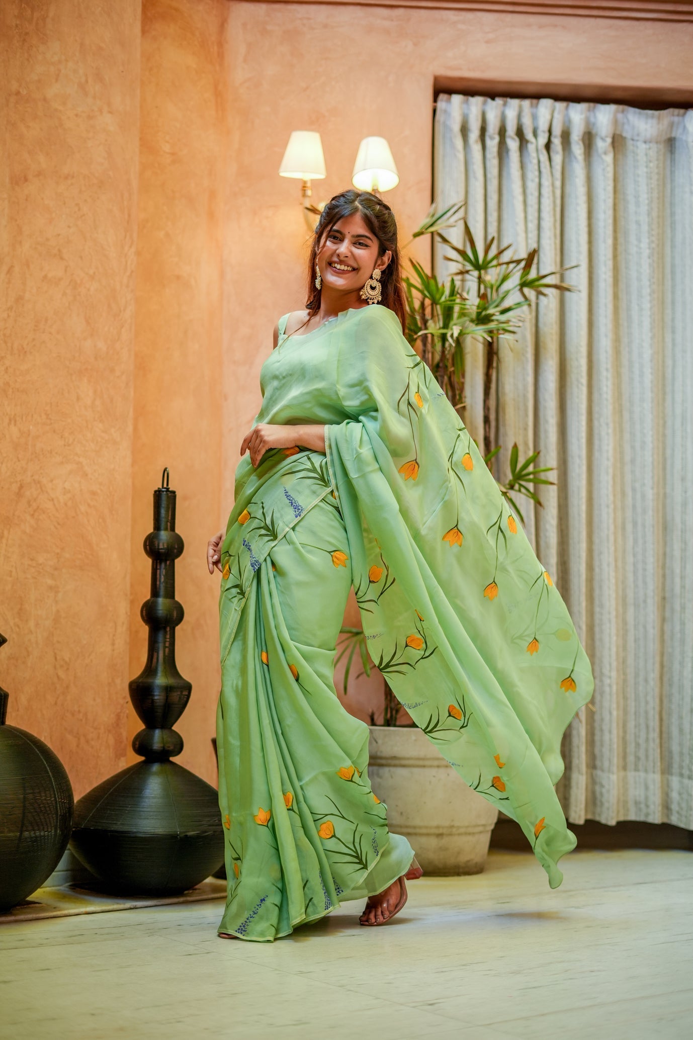 Elegant designer saree for women in light green with floral print, perfect for special occasions