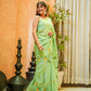 Model wearing a light green designer saree for women with floral patterns, showcasing elegance and style