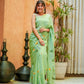 Elegant designer saree for women in light green with floral embroidery and a graceful drape