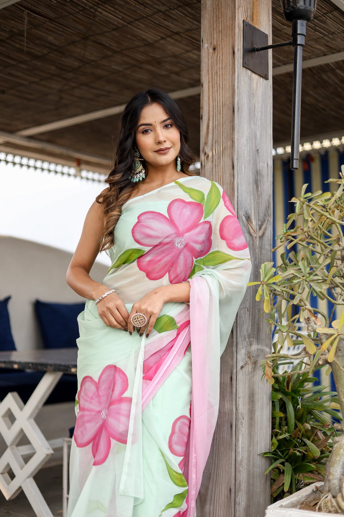 Elegant Stylera designer saree for women in pastel green with floral prints and soft draping