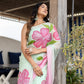 Elegant designer saree for women in light green with vibrant pink floral patterns, perfect for any occasion