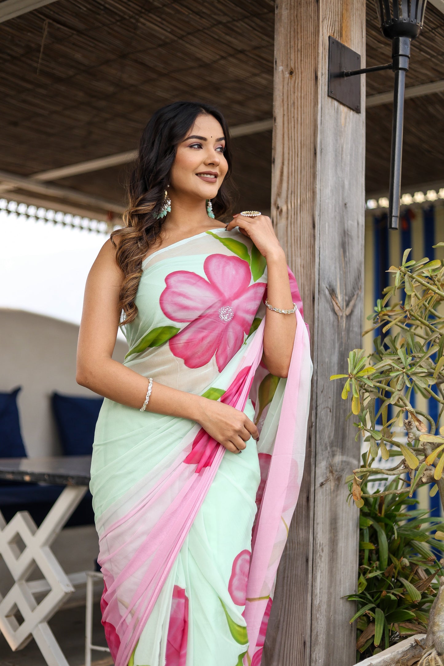 Elegant designer saree for women in light green with vibrant floral patterns, perfect for special occasions