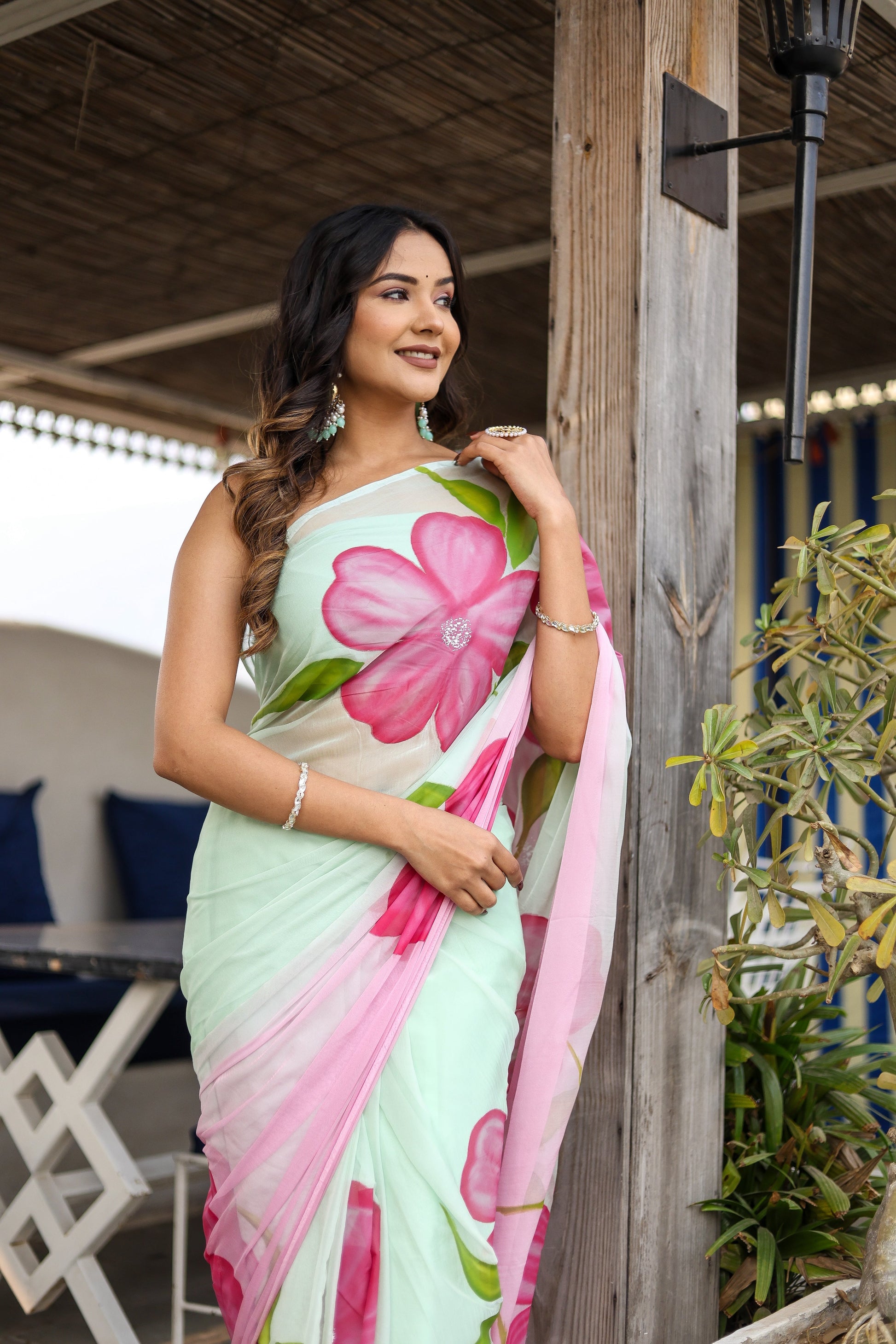 Elegant designer saree for women in light green with vibrant floral patterns, perfect for special occasions