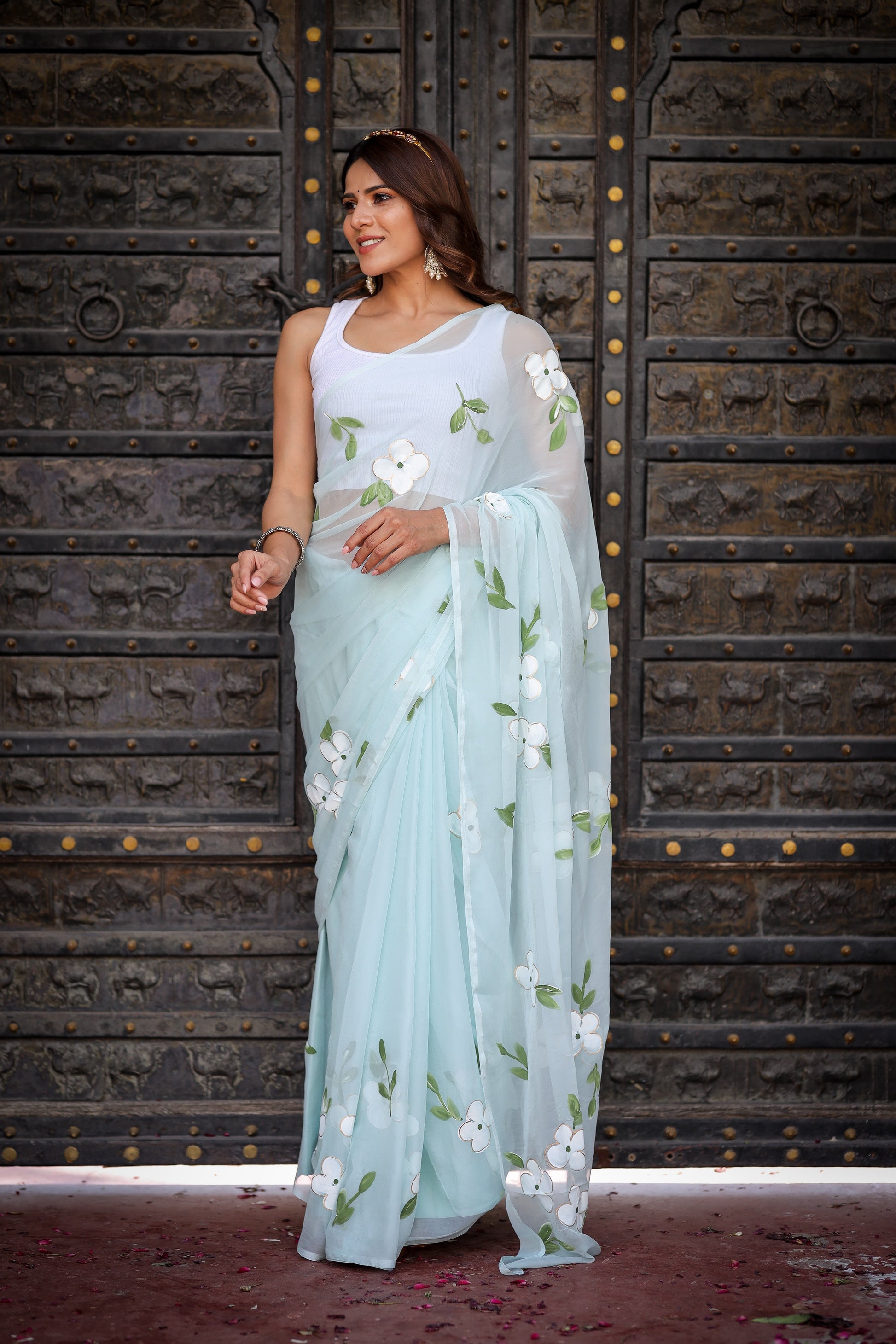 Light blue designer saree with floral embroidery, perfect for elegant occasions and celebrations