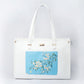 Large designer tote bag in white with a floral blue patch for stylish everyday use