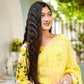 Model wearing a designer yellow saree hand painted with floral patterns, showcasing elegance and style
