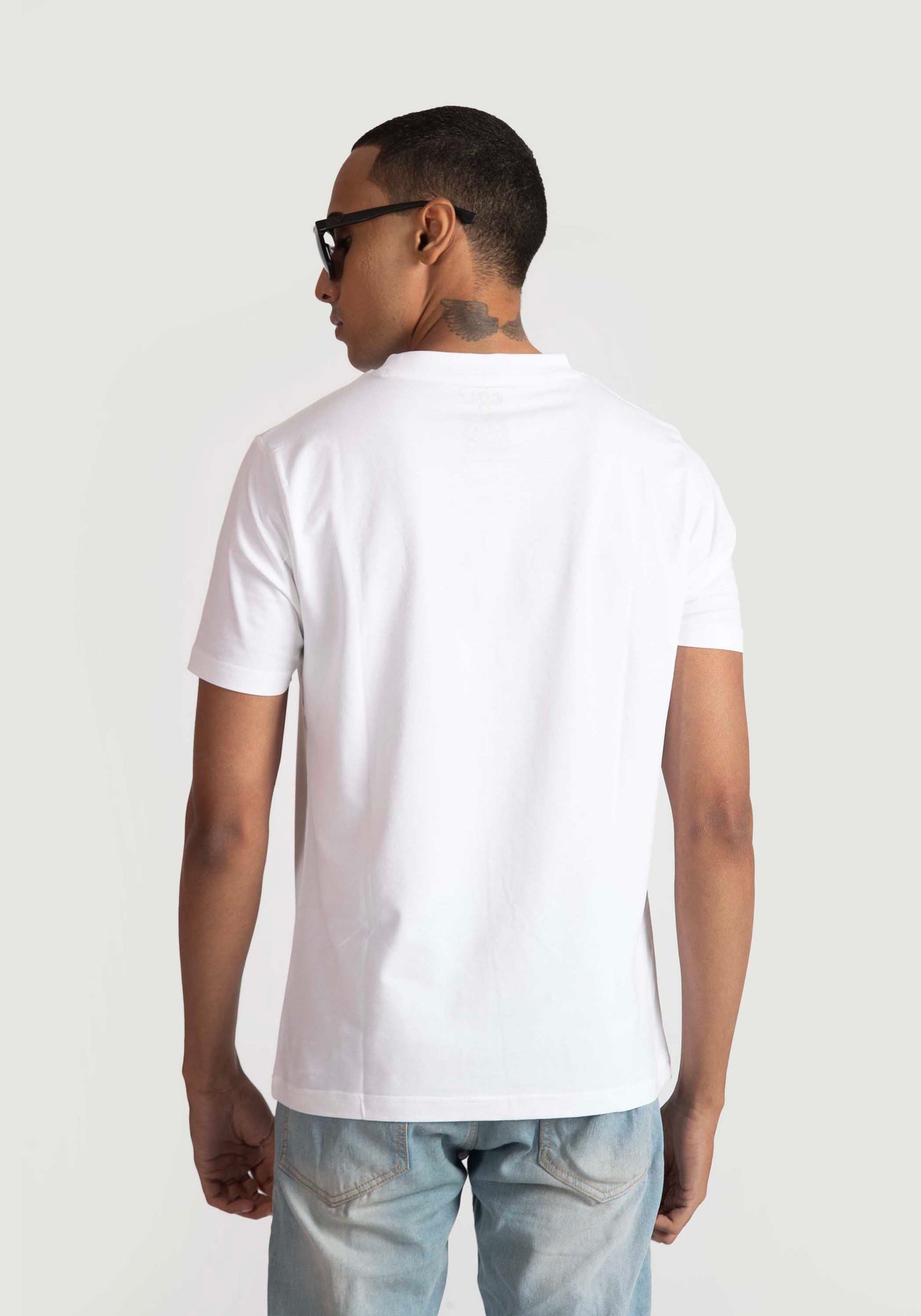Stylera white regular fit t-shirt shown from back worn by male model with sunglasses
